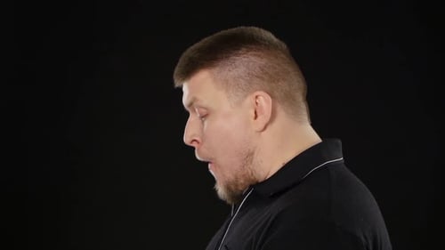 Man Eating a Burger on Black Background