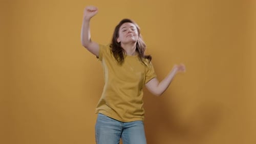 Positive Woman Full on Energy Dancing Alone in Studio Feeling Confident Moving to the Rithm of the