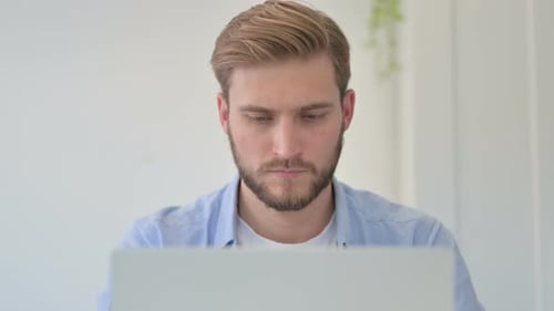 Portrait of Creative Man Working on Laptop in Office