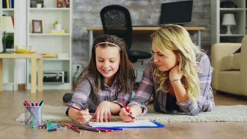 Mother and Daughter Drawing Together on Rug