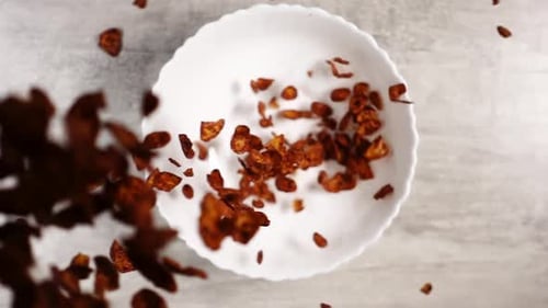 Chocolate Corn Flakes Being Poured Into Bowl