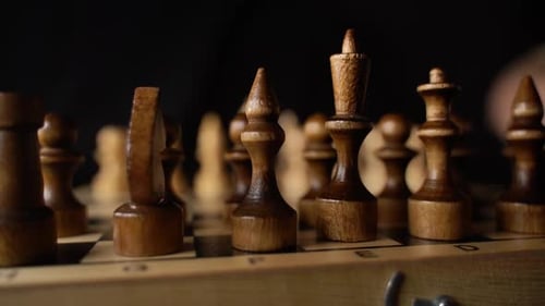 Close Up of Two Rows of Black Chess Pieces on Chessboard