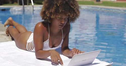 Charming Girl Using Laptop in Pool