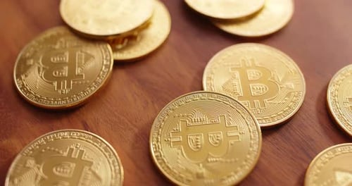 Golden Bitcoin Coins Close Up on Wooden Table