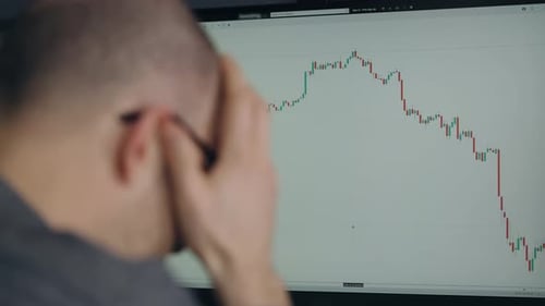 Ein Händler in einer Depression aufgrund eines Rückgangs der Börse oder der Kryptowährung