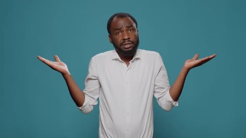 Man Shrugging His Shoulders with an I Don't Know Expression