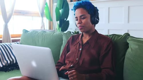 Young Adult with Blue Hair on Video Call at Home