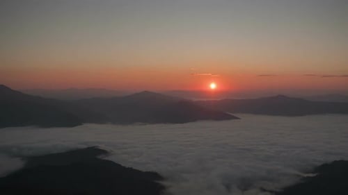 Mountains Rise Above Clouds at a Colorful Sunrise