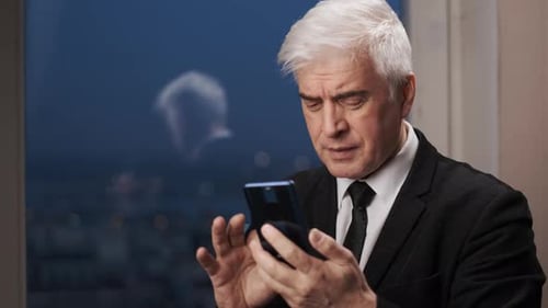 Mature Man Using Smartphone in an Urban Setting