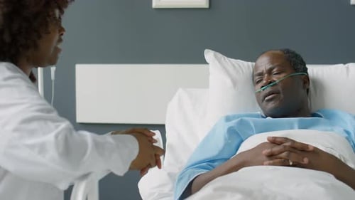 Cheerful Female Doctor Chatting with Patient in Hospital