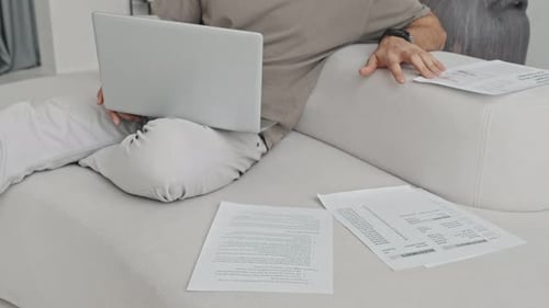 Young Adult Working Remotely at Home on Laptop