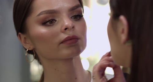 Woman Receiving Makeup Application in Studio Close Up