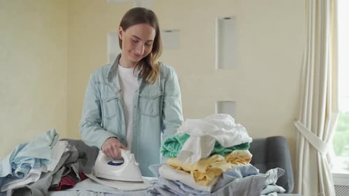 Woman Ironing Laundry in Home Interior