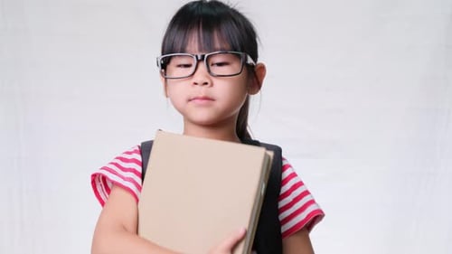 Smiling Girl With Glasses Gives a Thumbs Up