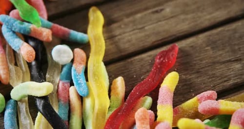 Gummy candies on a wooden table 4k