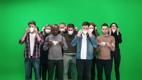 Cowd of People of Different Races and Ages Stands on a Green Background People Puts on Protective