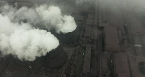 Aerial View of an Industrial Pipe Pollutes the Air Next To People Living in the City. Create a
