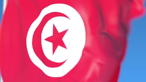 Tunisia Flag Waving Seamlessly Against a Blue Sky