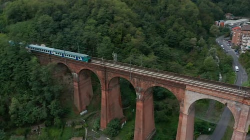 Aerial View. Old Railway bridge.Train Moves Across the Bridge.