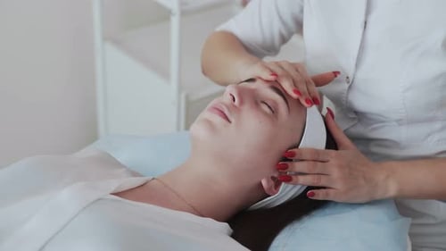 Woman Receiving Facial Massage in a Bright Spa