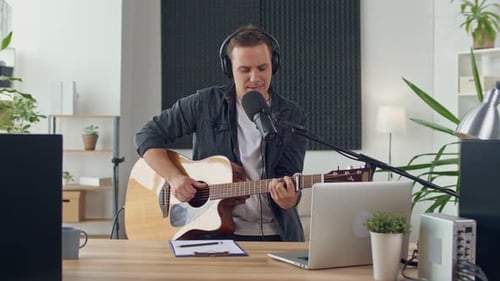 An Influential Musician With a Guitar Writes Music at Home Music Studio Spbd