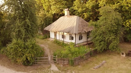Old Traditional Village House with Wicker Hedge