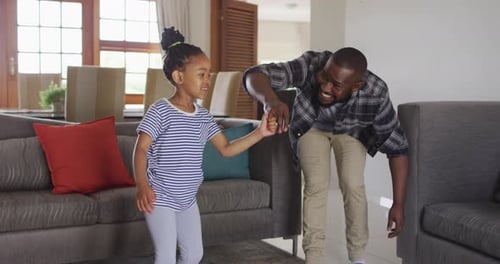 Father and Daughter Dancing Together at Home