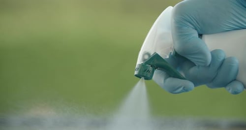 Spraying Liquid Sanitizer in a Close Up Shot