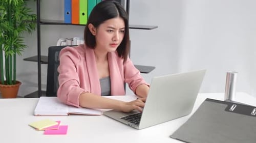 Young Asian business woman in office