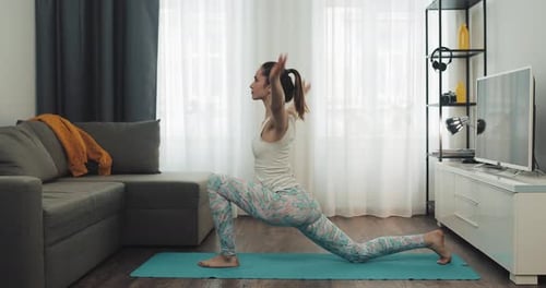 Young Woman Doing Yoga at Home
