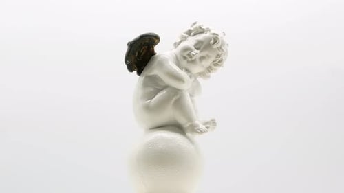 Beautiful Little Angel Statuette on a White Background