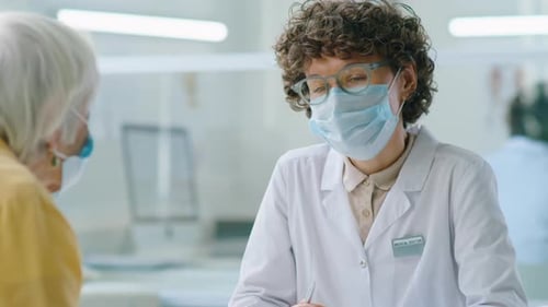 Young Medical Doctor Consults with Senior Patient