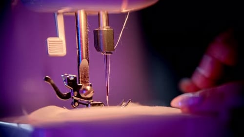 Sewing Machine Stitching Fabric with Hands Close Up