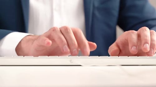 Close Up of Man Typing on Keyboard