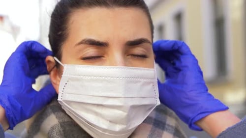 Young Woman Wearing Protective Face Mask in City