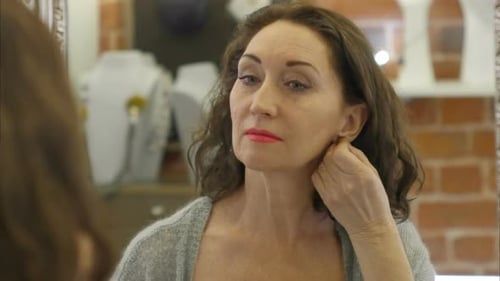 Woman Trying on Pearl Drop Earrings
