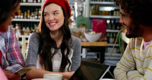 Friends Using Technology in a Cafe