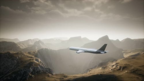 Passenger Aircraft Over Mountain Landscape