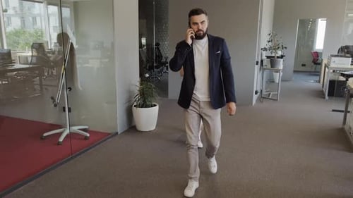 Businessman Talking On Phone In Office