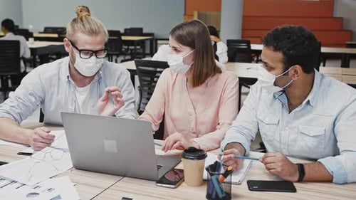 Teamwork in Modern Office with Masks
