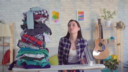 Bunch Clothes Falls on a Young Woman Housewife Slow Mo