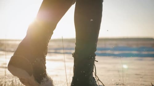 Legs Walking Across Snowy Winter Landscape