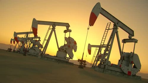 Oil pumps farm pumping the crude oil into pipelines at the desert environment.