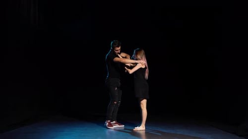 Romantic Choreography Against Black Background in Spotlight at Studio.