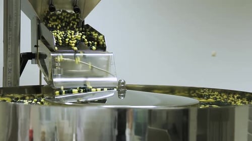 Machine Fills Small Capsules in Manufacturing Setting