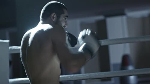 Shirtless Boxer Shadow Fighting in Ring