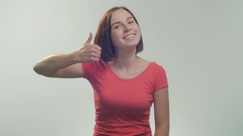 Smiling Woman Gives Thumbs Up Approval