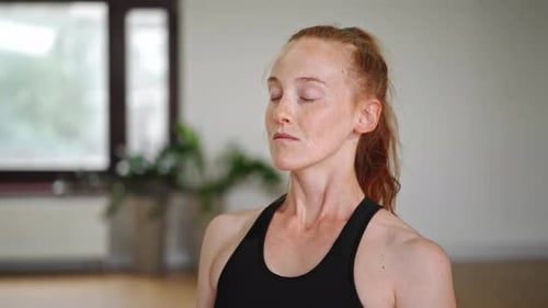 Close up: athletic woman doing yoga for health. The girl is in the lotus position