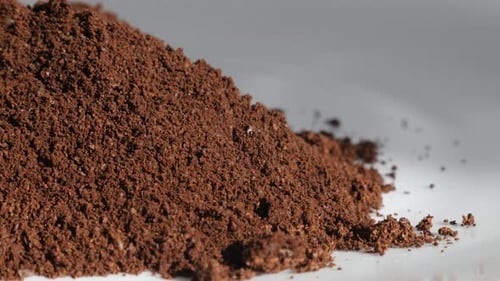 Pile of grounded coffee slow tilt 4K footage