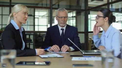 Mature Man Meditating in Office Tired of Shouting Colleagues, Reducing Stress